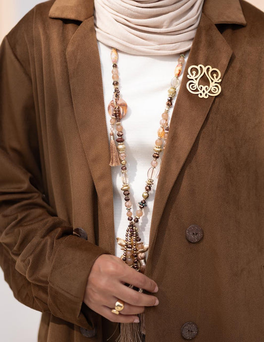 Iconic golden brooch