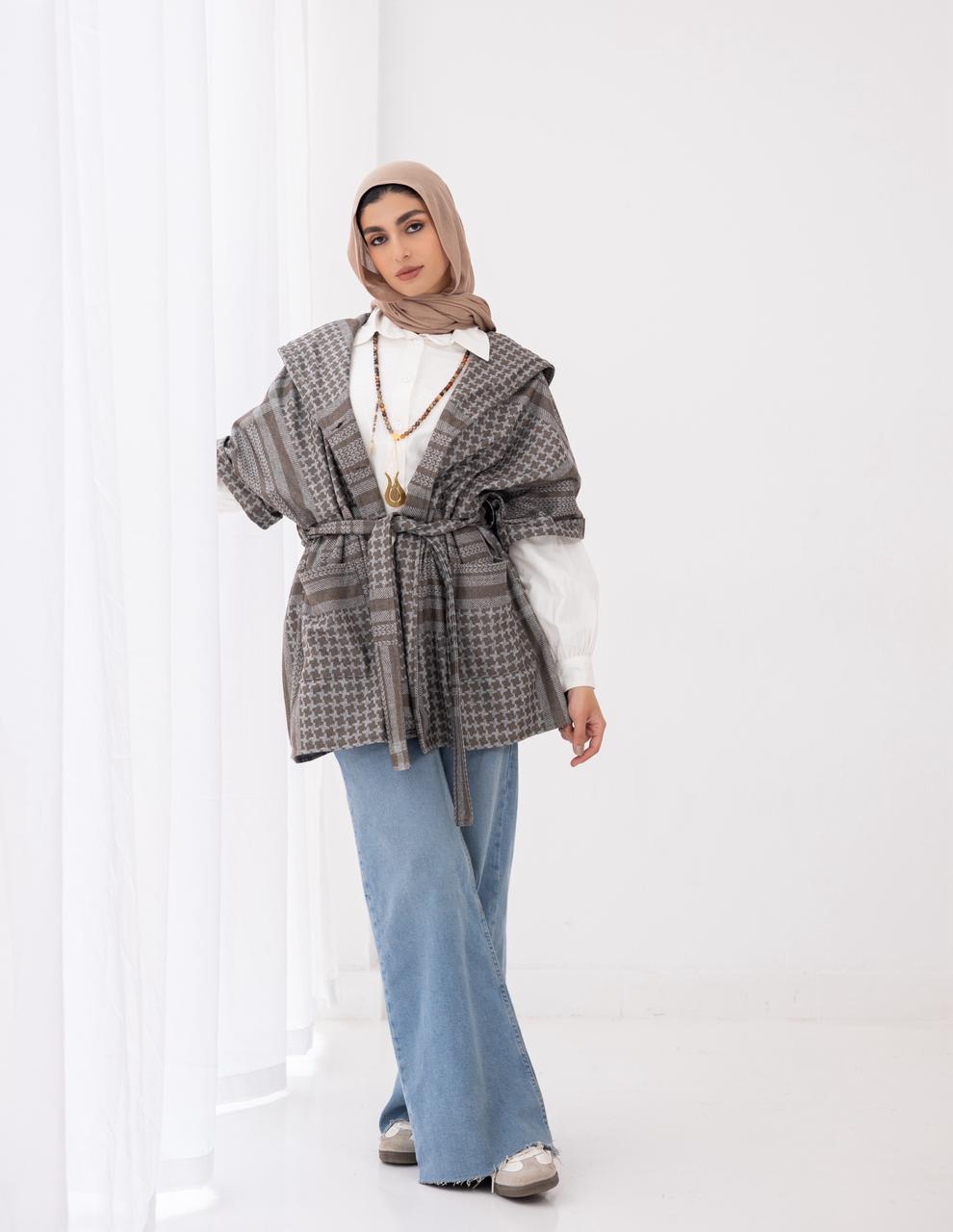 Palestinian heritage print coat in cafe