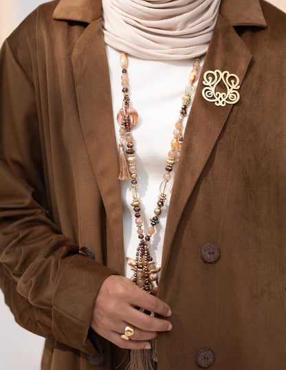 Iconic golden brooch