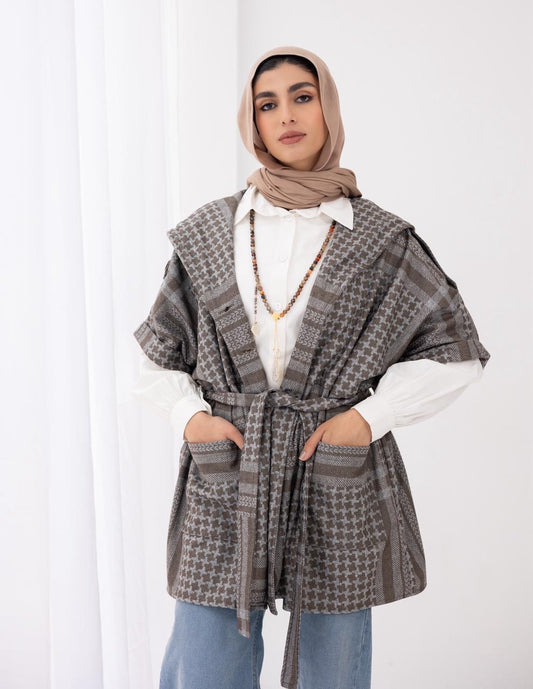 Palestinian heritage print coat in cafe